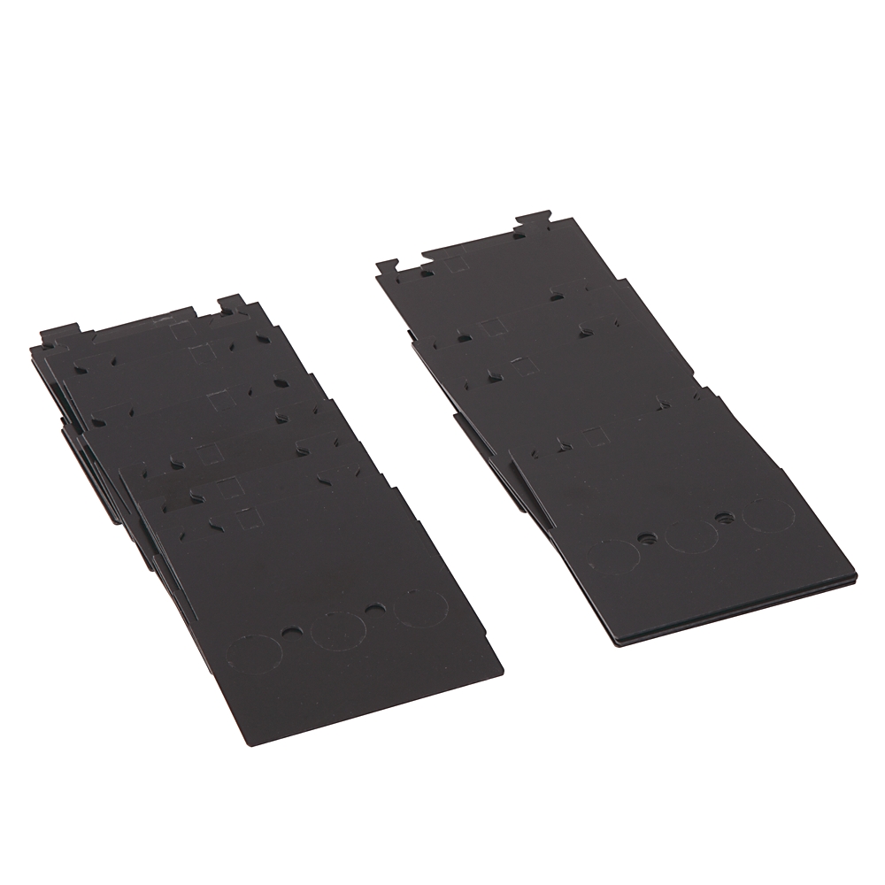 Two black plastic panels with interlocking edges laid flat on a white background.