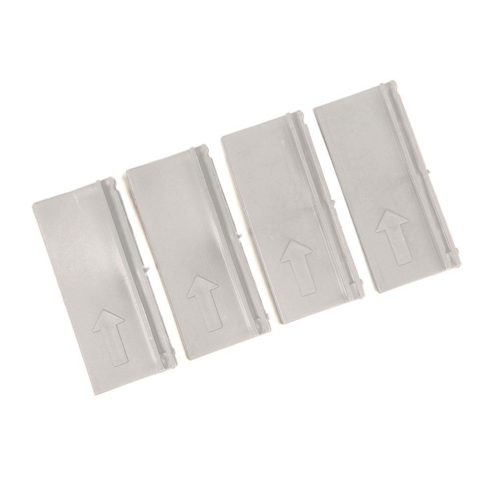 Four gray plastic tabs with upward pointing arrows, arranged diagonally.
