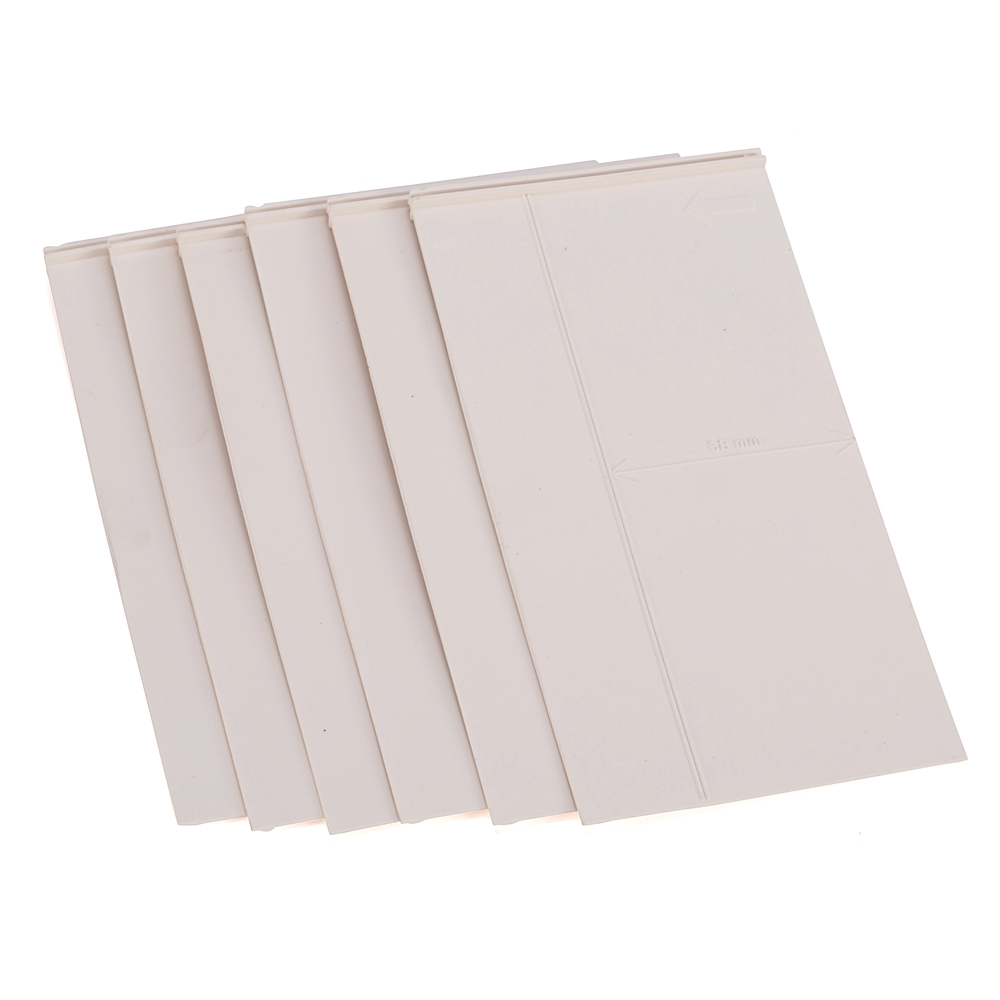 Five overlapping blank white plastic cards fanned out across a white background.