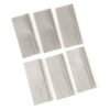 Six gray plastic pieces with upward arrows laid out in a loose grid pattern, likely spacers or tabs used in assembly.
