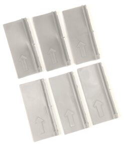 Six gray plastic pieces with upward arrows laid out in a loose grid pattern, likely spacers or tabs used in assembly.