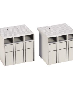 Two white modular terminal blocks with three vertical slots each, used for wiring connections on a electrical panel at a desk setup.