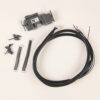 Wiring harness with multiple black cables, a gray modular electronic unit, mounting brackets, and white connector plugs on a white background.