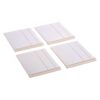 Four white square plastic tiles with two shallow grooves and an arrow mark, arranged in a cluster; likely tile spacers used in tiling.