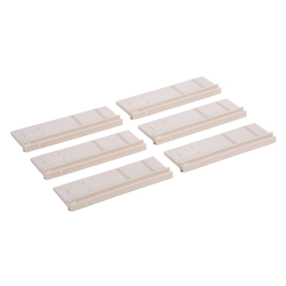 Set of six beige plastic rail segments with arrows embossed, laid out on a white background