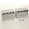 Two gray modular storage units with four vertical drawer columns on a white surface, plus small scale items nearby.