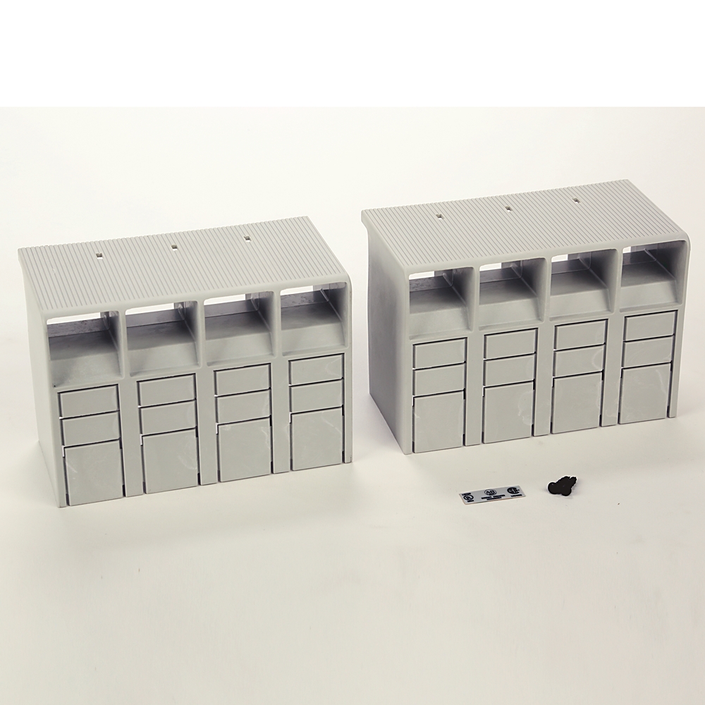 Two gray modular storage units with four vertical drawer columns on a white surface, plus small scale items nearby.