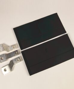 Two black flat battery cells with silver metal terminal lugs on the left side beside them.