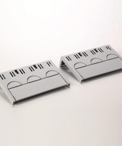 Two gray plastic cable organizers lying on a white surface, each with multiple slots for guiding and bundling wires.