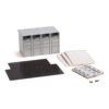 Unassembled four-bay server chassis with drive bays, side panels, mounting brackets and screws laid out on a white background