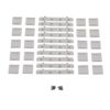 Assortment of gray plastic mounting brackets and small screws spread on a white background