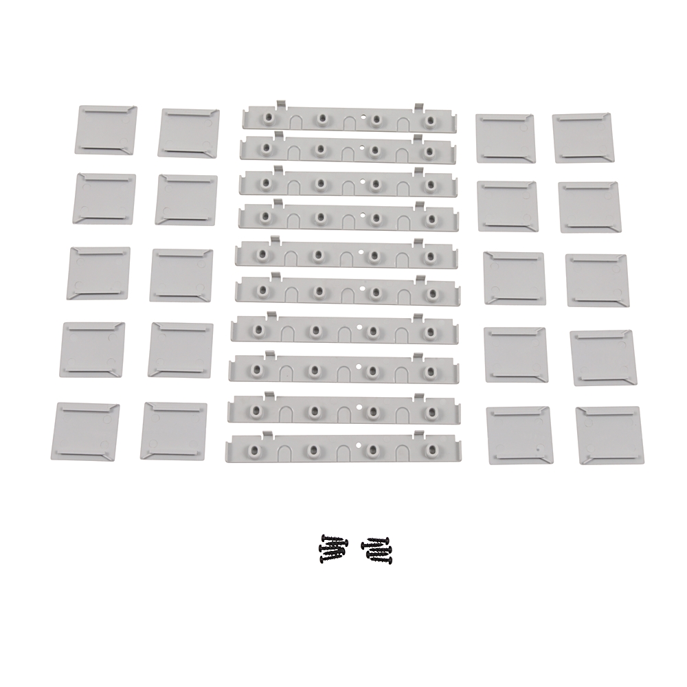 Assortment of gray plastic mounting brackets and small screws spread on a white background