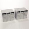 Two gray modular storage units with three open cubby spaces on top and three drawers below.