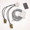 Two adhesive medical electrodes with attached wires, plus a white interface plug and a coiled gray data cable for patient monitoring.