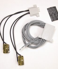 Two adhesive medical electrodes with attached wires, plus a white interface plug and a coiled gray data cable for patient monitoring.