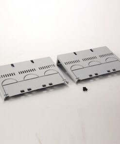 Two light-gray vented panels (server rack blanks) with curved cutouts, placed on a white surface with a few small black screws nearby