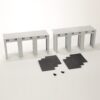 Two gray scale-model bridge-like frames with four legs and a ribbed top, plus dark foam sheets and tiny screws on a white surface (model kit parts).