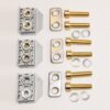 Three gray terminal blocks with brass screws and metal mounting plates, plus bolts, washers, and spacers arranged in three vertical rows.