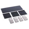 Flat mounting kit with a large dark rectangular plate, three smaller black panels, and four white brick-like blocks with six holes each.