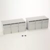 Two light-gray modular cabinet units with vented tops, each featuring three doors, placed on a white background with two small black screws in front (toy/model scale).