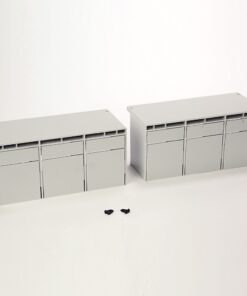 Two light-gray modular cabinet units with vented tops, each featuring three doors, placed on a white background with two small black screws in front (toy/model scale).