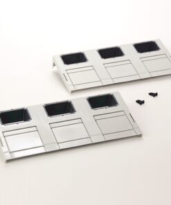 Two white plastic mounting panels with three square openings each and small sliding covers, laid on a white surface with two screws nearby.