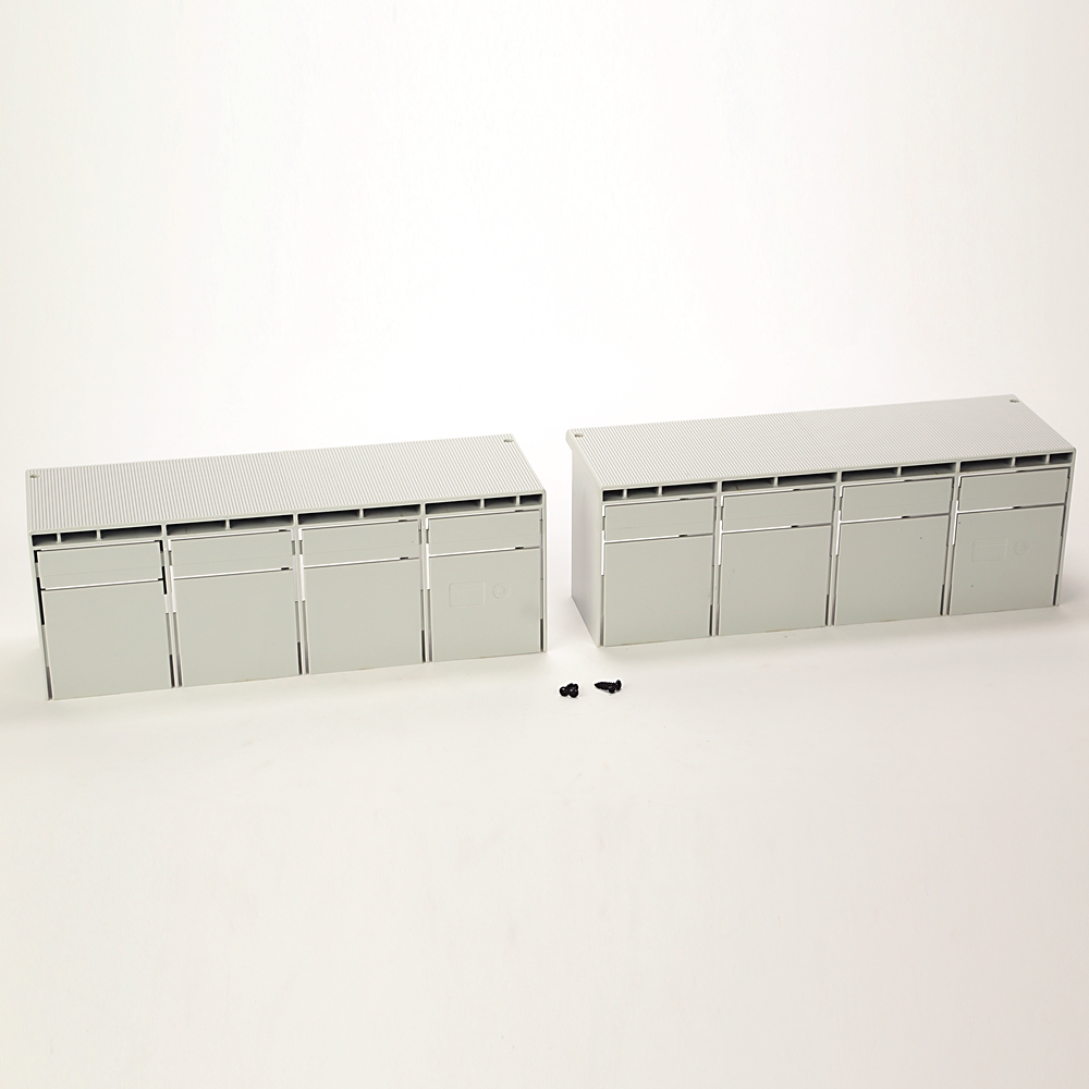 Pair of gray modular storage cabinets with multiple front panels on a white background; small screws sit between them.