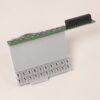 White plastic electronic module with a row of plug-in terminals at the base and a green circuit board with a black multi-pin connector on top.
