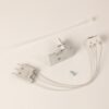 White electrical fixture kit components: a plug connector, metal mounting bracket, white wire leads, and a small screw.