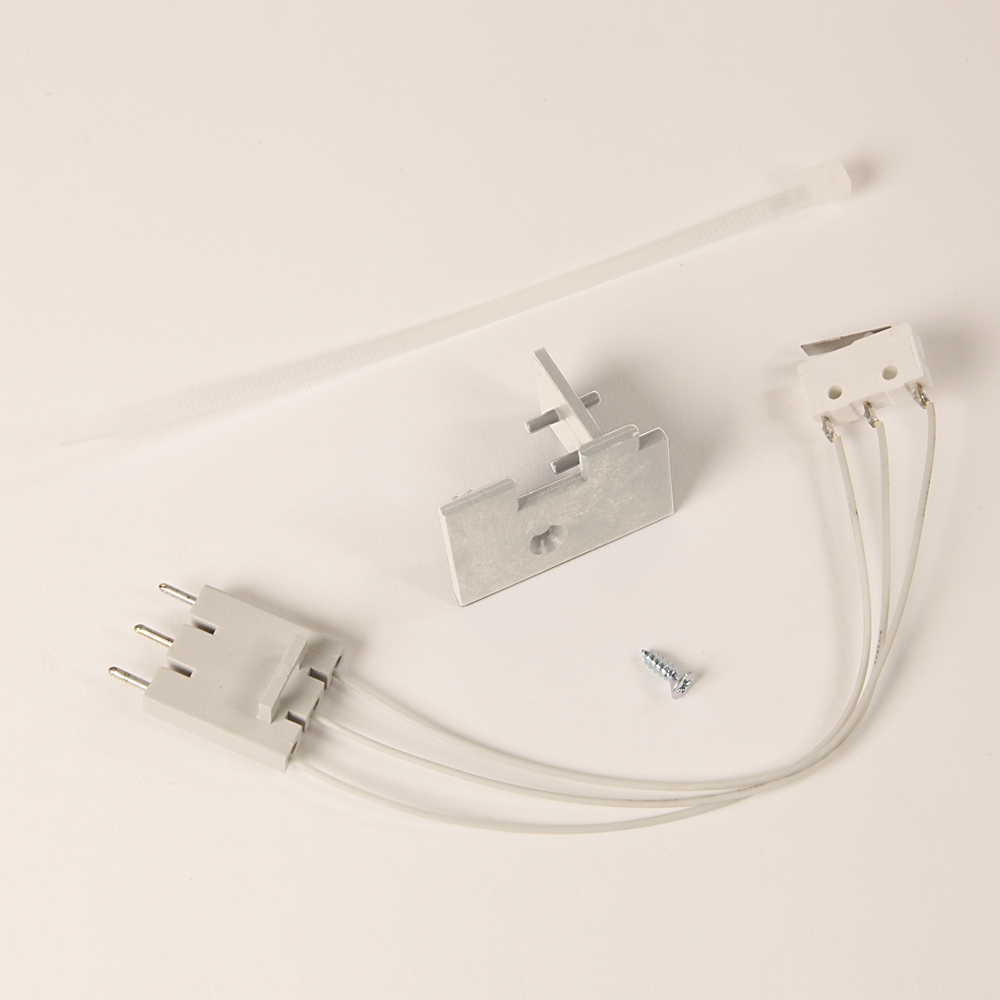 White electrical fixture kit components: a plug connector, metal mounting bracket, white wire leads, and a small screw.