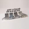 Set of four silver metal brackets with multiple holes, arranged in a row, with several small black screws laid above them.