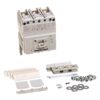 Assorted electrical components: a three-pole circuit breaker with mounting hardware, screws, washers, and plastic mounting brackets laid out.