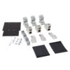Assorted electrical terminal blocks, connectors, mounting plates, screws, and insulating sheets laid out for assembly.