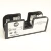 Allen-Bradley electrical component with model 1491-R165 label and two metal clamps (black plastic casing)