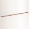 Long white ruler-like strip with orange teeth along one edge, laid diagonally on a white background.