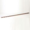 Long straight metal rail with orange clips along its length, placed on a white surface (industrial/mechanical component).