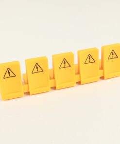 Six yellow safety tiles with high-voltage warning symbols arranged in a row (toy-like blocks).