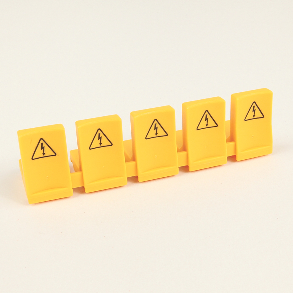 Six yellow safety tiles with high-voltage warning symbols arranged in a row (toy-like blocks).