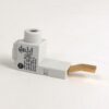 White plastic electrical connector with a flat copper strip extending to the right, used as a contact terminal