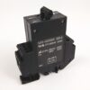 Industrial electrical contactor/relay with a black rectangular body and terminal blocks, shown at an angle with a coil on top.