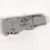 Gray plastic model part with multiple attachment pegs and a molded code reading 492-GSTP on a flat surface.