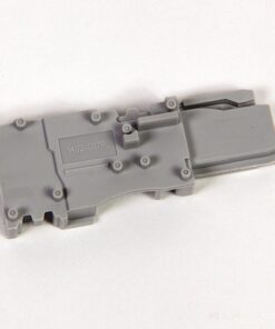 Gray plastic model part with multiple attachment pegs and a molded code reading 492-GSTP on a flat surface.
