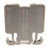 Gray plastic electrical connector block with two bottom hooks and a central warning label, used for mounting or joining electrical modules.