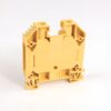 Yellow plastic electrical terminal block housing with mounting feet, viewed from the side showing terminal slots and connectors.
