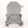 Gray modular electrical terminal block viewed from front, with screw-terminal sections on top and mounting feet for panel installation.