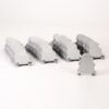 Row of light-gray modular train-like models lined up on a white background fielded in several diagonal rows, with one detached piece in the foreground