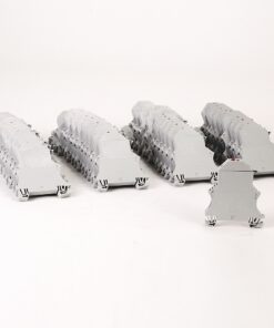 Row of light-gray modular train-like models lined up on a white background fielded in several diagonal rows, with one detached piece in the foreground