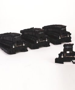 Black modular electrical components with copper connectors arranged in rows on a white surface.