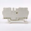 White compact electrical circuit-breaker/module viewed from the side, showing mounting feet, terminal openings, and faint labeling on the casing.