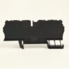 Black plastic modular electrical component with mounting clips, viewed from the side (likely a terminal block or DIN rail module).